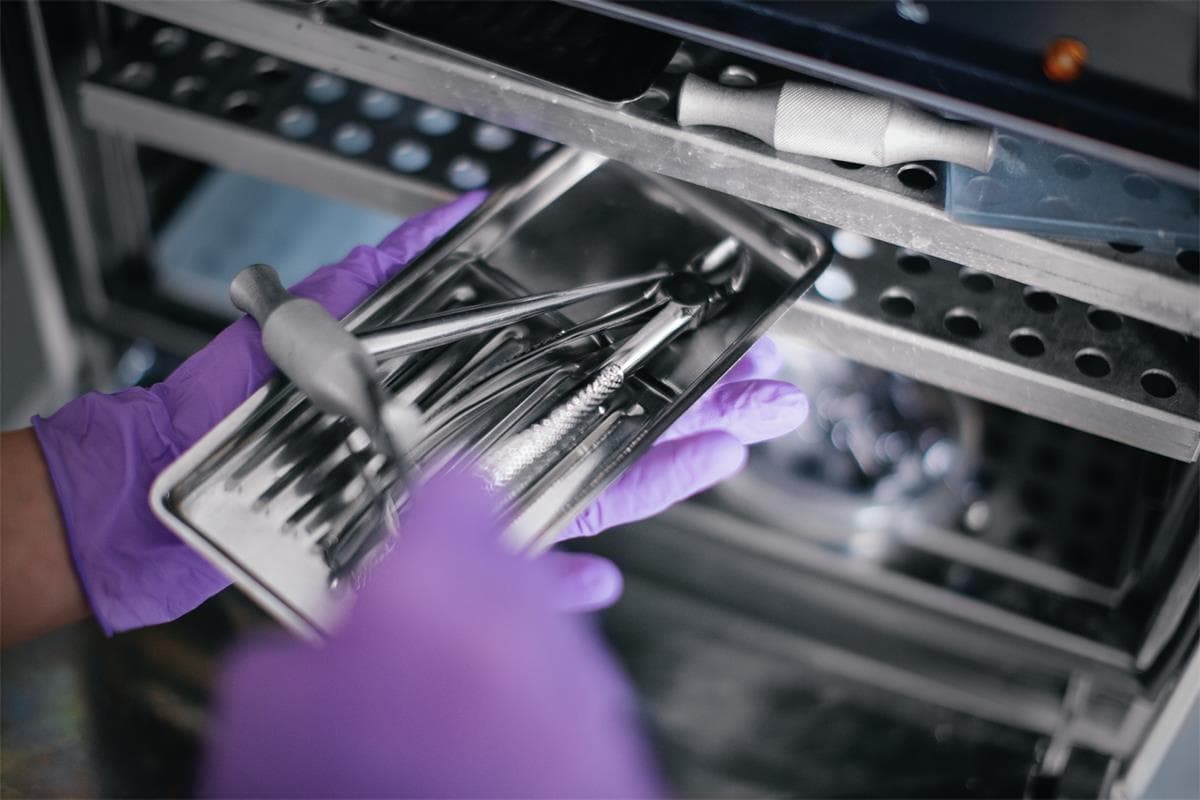 Sterile processing technician handling instruments